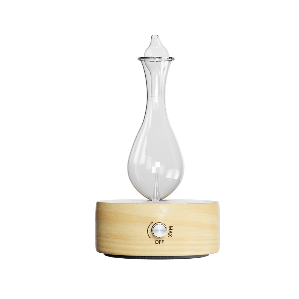 Essential oil glass diffuser with a wooden base. Dial on wooden base goes to control intensity.