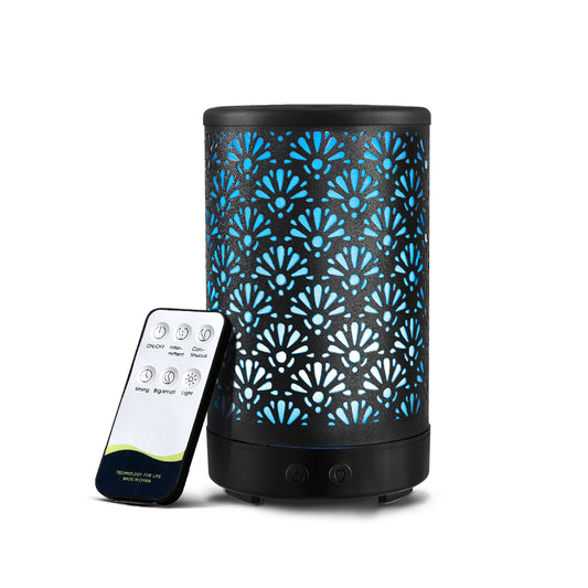 Aromatherapy essential oil diffuser with a stylish metal cover featuring an intricate fanned design and soothing LED lighting